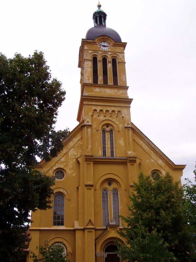 Veža kostola s hodinami a zvonicou na historickom mieste.